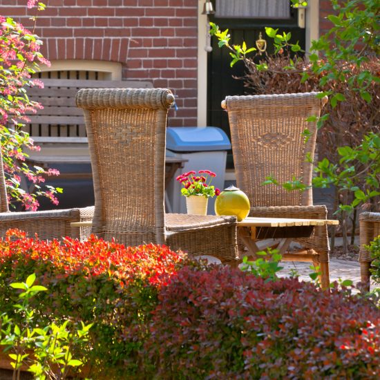Wicker chairs in the front garden. Very cozy and rustic.